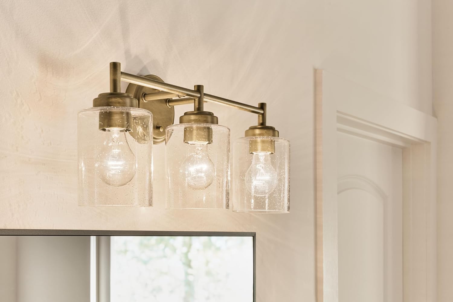 Kichler Winslow 21.5' 3-Light Bathroom Vanity Light Fixture with Clear Seeded Glass in Natural Brass for Luxe Industrial Style Over Mirror (21.5' x 9.25'), 45886NBR